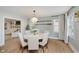Bright dining room with elegant chandelier, hardwood floors, and seating for six at 10243 Brixton Ln, Fishers, IN 46037