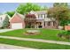 Charming two-story home with a brick and siding exterior, and lush green lawn at 10243 Brixton Ln, Fishers, IN 46037
