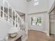 Bright foyer featuring a staircase, hardwood floors, and a view to the front yard at 10243 Brixton Ln, Fishers, IN 46037