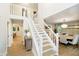 Welcoming foyer with staircase, hardwood floors, and natural light throughout at 10243 Brixton Ln, Fishers, IN 46037
