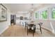 Eat-in kitchen with white cabinets, stainless appliances, and large windows at 10243 Brixton Ln, Fishers, IN 46037