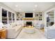 Cozy living room with built-in shelves, fireplace, and comfortable seating area at 10243 Brixton Ln, Fishers, IN 46037