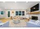 Bright living room features fireplace, built-in shelving, and neutral furniture at 10243 Brixton Ln, Fishers, IN 46037