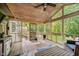 Screened-in porch with wood flooring, ceiling fan, and views of the backyard at 10243 Brixton Ln, Fishers, IN 46037