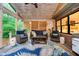 Inviting screened porch features wood accents, comfortable furniture, and outdoor living space at 10243 Brixton Ln, Fishers, IN 46037