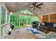 Relaxing screened-in porch with vaulted ceilings, comfortable seating, and backyard views at 10243 Brixton Ln, Fishers, IN 46037