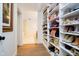 Spacious walk-in closet with custom shelving offers ample storage for shoes and accessories at 10243 Brixton Ln, Fishers, IN 46037