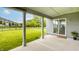 Covered back porch with a view of the green lawn and nearby walking trail at 10922 Liberation Trce, Noblesville, IN 46060