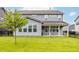 Spacious backyard with a young tree, privacy fence, and view of the home's exterior at 10922 Liberation Trce, Noblesville, IN 46060