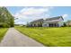 Backyard of modern home showing manicured lawns, privacy fence, and a walking trail beyond at 10922 Liberation Trce, Noblesville, IN 46060