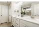 Bright bathroom featuring a double vanity and large mirror, white cabinets and tile flooring at 10922 Liberation Trce, Noblesville, IN 46060