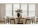 Dining room showcasing a wooden table, seating for six, and a large window with natural light at 10922 Liberation Trce, Noblesville, IN 46060