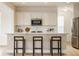 Bright kitchen featuring white cabinets, stainless steel appliances, and a center island with seating at 10922 Liberation Trce, Noblesville, IN 46060