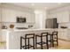 Modern kitchen featuring a center island with seating, stainless steel appliances, and light wood floors at 10922 Liberation Trce, Noblesville, IN 46060