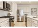 Contemporary kitchen with stainless steel appliances, white subway tile backsplash, and modern fixtures at 10922 Liberation Trce, Noblesville, IN 46060