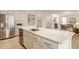 Spacious kitchen with stainless steel appliances, white cabinets, and a large center island open to the living room at 10922 Liberation Trce, Noblesville, IN 46060
