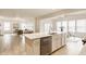 Open-concept kitchen featuring a large island with seating, stainless steel appliances, and views into the living area at 10922 Liberation Trce, Noblesville, IN 46060