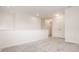 Bright and airy living room with neutral carpet and access to hallway with large closet doors at 10922 Liberation Trce, Noblesville, IN 46060