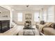 Cozy living room featuring a fireplace, stylish decor, neutral tones, and hardwood floors at 10922 Liberation Trce, Noblesville, IN 46060