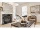 Comfortable living room has a fireplace and staircase to the second floor at 10922 Liberation Trce, Noblesville, IN 46060