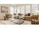Inviting living room features a comfortable sofa, stylish decor, large windows, and hardwood floors at 10922 Liberation Trce, Noblesville, IN 46060