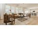 Bright open-concept living room features hardwood floors, neutral decor, and seamless flow to the kitchen at 10922 Liberation Trce, Noblesville, IN 46060