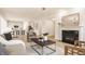 Open-concept living room flows to the kitchen and features a fireplace, hardwood floors, and modern decor at 10922 Liberation Trce, Noblesville, IN 46060