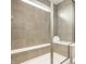 Bright tiled shower area featuring a built-in bench and glass enclosure at 10922 Liberation Trce, Noblesville, IN 46060