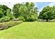 Green backyard with mature trees and shed at 1102 Fox Hill Dr, Indianapolis, IN 46228