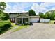 Exterior view of a two-story home with a driveway and lots of greenery at 1102 Fox Hill Dr, Indianapolis, IN 46228