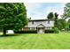 Charming two-story home featuring well-maintained landscaping and a lush green lawn at 1102 Fox Hill Dr, Indianapolis, IN 46228