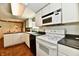 Efficient kitchen with white cabinets, dark countertops, and essential appliances, offering practical cooking space at 1102 Fox Hill Dr, Indianapolis, IN 46228