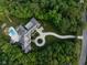 Stunning aerial view of an estate nestled among lush trees, featuring a pool, driveway and basketball court at 11101 Hawthorn Rdg, Fishers, IN 46037