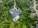 An aerial view of the backyard that features a pool, playground, and lush landscaping at 11101 Hawthorn Rdg, Fishers, IN 46037