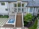 Large backyard with stairs leading to a terrace and hot tub at 11101 Hawthorn Rdg, Fishers, IN 46037