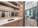 Custom bar featuring marble countertops, wooden cabinets, and decorative shelving with interior design in background at 11101 Hawthorn Rdg, Fishers, IN 46037