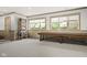 Basement shuffleboard area with windows, seating area, and decorative storage at 11101 Hawthorn Rdg, Fishers, IN 46037