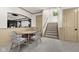 Neutral basement living area features a carpet, stairs, and a small table with 4 chairs at 11101 Hawthorn Rdg, Fishers, IN 46037