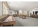 Large basement rec room with kitchenette, billiards, shuffleboard and stairs to the main level at 11101 Hawthorn Rdg, Fishers, IN 46037