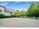 A concrete basketball court is surrounded by lush landscaping and greenery offering a private recreational space at 11101 Hawthorn Rdg, Fishers, IN 46037