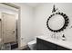 Elegant bathroom featuring a dark vanity, modern mirror, toilet, and tiled walk-in shower at 11101 Hawthorn Rdg, Fishers, IN 46037