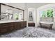 Bathroom featuring elegant soaking tub, custom vanity, and natural light at 11101 Hawthorn Rdg, Fishers, IN 46037