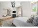 Bright bedroom features wood floors, unique chandelier, television, ensuite workspace, and horse-themed wallpaper at 11101 Hawthorn Rdg, Fishers, IN 46037