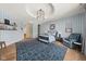 Stylish bedroom with blue striped wallpaper, a modern bed frame, and a cozy armchair at 11101 Hawthorn Rdg, Fishers, IN 46037