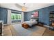 Serene bedroom showcasing blue wallpaper, large window, and a comfortable bed setup at 11101 Hawthorn Rdg, Fishers, IN 46037