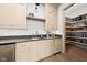 Convenient bar area with ample cabinet space, a sink, under-counter refrigeration, and easy access to the pantry at 11101 Hawthorn Rdg, Fishers, IN 46037