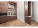 Large custom closet featuring dark wood cabinets, shelves, and a sink/bar area at 11101 Hawthorn Rdg, Fishers, IN 46037
