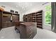 Spacious closet with custom wood shelving, center island, carpeting, and modern light fixture at 11101 Hawthorn Rdg, Fishers, IN 46037
