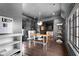 Dark painted dining room with wood floors features a modern light fixture and built-in shelving at 11101 Hawthorn Rdg, Fishers, IN 46037