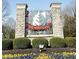 Elegant stone entrance to The Hawthorns, showcasing lush landscaping and a welcoming community atmosphere at 11101 Hawthorn Rdg, Fishers, IN 46037